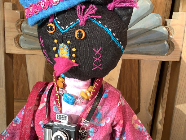 Ruby the Rainbow Owl Plays Tourist at the Rail Yard Market by KD Rivera