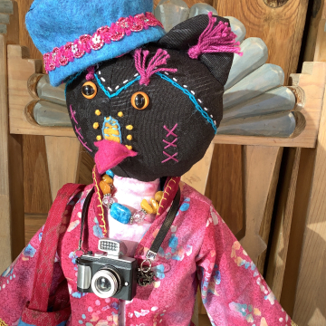 Ruby the Rainbow Owl Plays Tourist at the Rail Yard Market by KD Rivera
